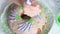 Sugar cupcake. Woman draws lavender flowers on a cupcake. With icing, using a pastry bag. Shot from above