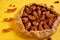 Sugar free pie with plums and raisins on yellow wooden background close up decorated with brown raisins and dried pieces of apple