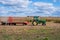 Sugar Grove, IL/USA - 10-04-2020:  Tractor with wagons attached in rural countryside