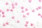 sugar hearts colored white and pink, spreading on white background