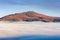 The Sugar Loaf mountain rising above fog and a cloud inversion Crickhowell, Wales