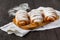 Sugar powder is poured onto a freshly baked croissan