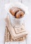 Sugar powdered cinnamon doughnuts in a metal bucket on white wooden background