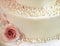 Sugar roses with pearls on the cake closeup