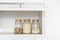 Sugar, semolina and muesli in glass jar. Food products in domestic kitchen storing. Horizontal