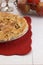 Sugar Sprinkled Homemade Apple Pie Isolated on a White Wood Table