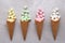 Sugar Waffle Ice Cream Cones filled with colorful marshmallows spilling onto tile table