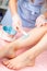 Sugar and waxing depilation of the feet in the beauty salon. Rid of hair on the legs. Sugaring. Master cosmetologist