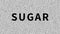 Sugar. Word about food problem on noisy old screen. Looping VHS interference. Vintage animated background, video footage