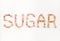 SUGAR written with brown sugar pieces