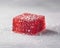 Sugared Red Gummy Cube on Subtle Grey Background