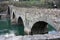 The suggestive and famous Ponte del Diavolo of Lucca built in bricks over a river in an ancient medieval village in Borgo a