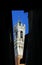 Suggestive glimpse of the Tower of Siena called TORRE DEL MANGIA among the dark buildings in Italy