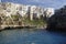 Suggestive landscape view on dramatic cliffs with caves rising from Adriatic sea in Polignano a Mare