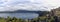 Suggestive overview at Albano Lake with Castel Gandolfo city skyline the wooded slopes of volcanic caldera wrapped in a fantastic