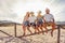 Suggestive photography with backlight sun effect of four young happy people enjoying outdoor life in exotic vacation resort