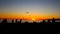 Suggestive Sunset on the beach with silhouettes of people watching sunset