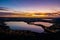 A suggestive sunset is reflected on three Italian lakes.