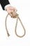 Suicide and business topic: Hand of a businessman in a black jacket holding a loop of rope for hanging on white isolated