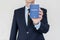 Suit Up Business Man holding universal passport in right hand