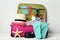Suitcase with clothes, sunglasses, starfish