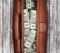 Suitcase full of dollars on a wooden background.