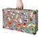 Suitcase in hand with stickers of flags of countries from travel