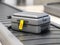 Suitcase with lost sticker on an airport baggage conveyor or baggage claim transporter