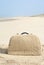 Suitcase made out of sand on beach