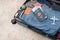 suitcase is packed for travel - Levi\\\'s jeans, an American passport and dollars, a camera and other things