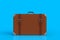 Suitcase of a traveler isolated on blue background
