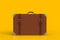 Suitcase of a traveler isolated on yellow background