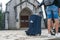 Suitcase of traveler in Sapa town, Vietnam. Stone church on background. Travel concept