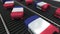 Suitcases featuring flag of France move on the conveyor in an airport. French tourism related loopable animation