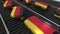 Suitcases featuring flag of Germany move on the conveyor in an airport. German tourism related loopable animation