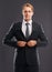 Suiting up. Portrait of a handsome man in a business suit in front of a gray background.