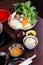 Sukiyaki vegetables set including cabbage, false pak choi, carrot, shiitake, enokitake and tofu in bamboo basket