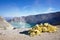 The sulfuric lake of Kawah Ijen vulcano in East Java with sulfur stone in foreground