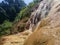 sulphurous hot waterfall with a jungle feel