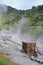 Sulphurous mountain valley with hot spring stream and steam at Tamagawa Onsen Hot spring in Senboku city, Akita prefecture, Japan