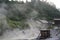 Sulphurous mountain valley with hot spring stream and steam at Tamagawa Onsen Hot spring in Senboku city, Akita prefecture, Tohoku