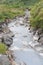 Sulphurous mountain valley with hot spring stream and steam at Tamagawa Onsen Hot spring in Senboku city, Akita prefecture, Tohoku