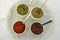 Sumac, mint, red paprika, thyme. dried spices in small bowls.