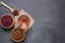 Sumac water or tea and dried ground red Sumac spices in wooden spoon with sumac berries on rustic table