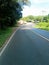 Sumatra crossing road in the afternoon with oil palm plantations and mahogany trees on the right and left