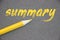 Summary word hand written in yellow letters with pencil besides on grey background. Business photo Brief Statement Abstract