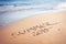 Summer 2015 handwriting on a sandy beach.