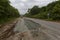 Summer, 2016 - Primorsky Krai, Russia - The car drives on a bad asphalt road. Killed Russian roads