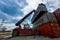 Summer, 2016 - Primorsky Krai, Russia - Container terminal. Large forklift lifts a metal container