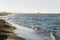 Summer afternoon on the beach with people doing kitesurf in Mediterranean Sea